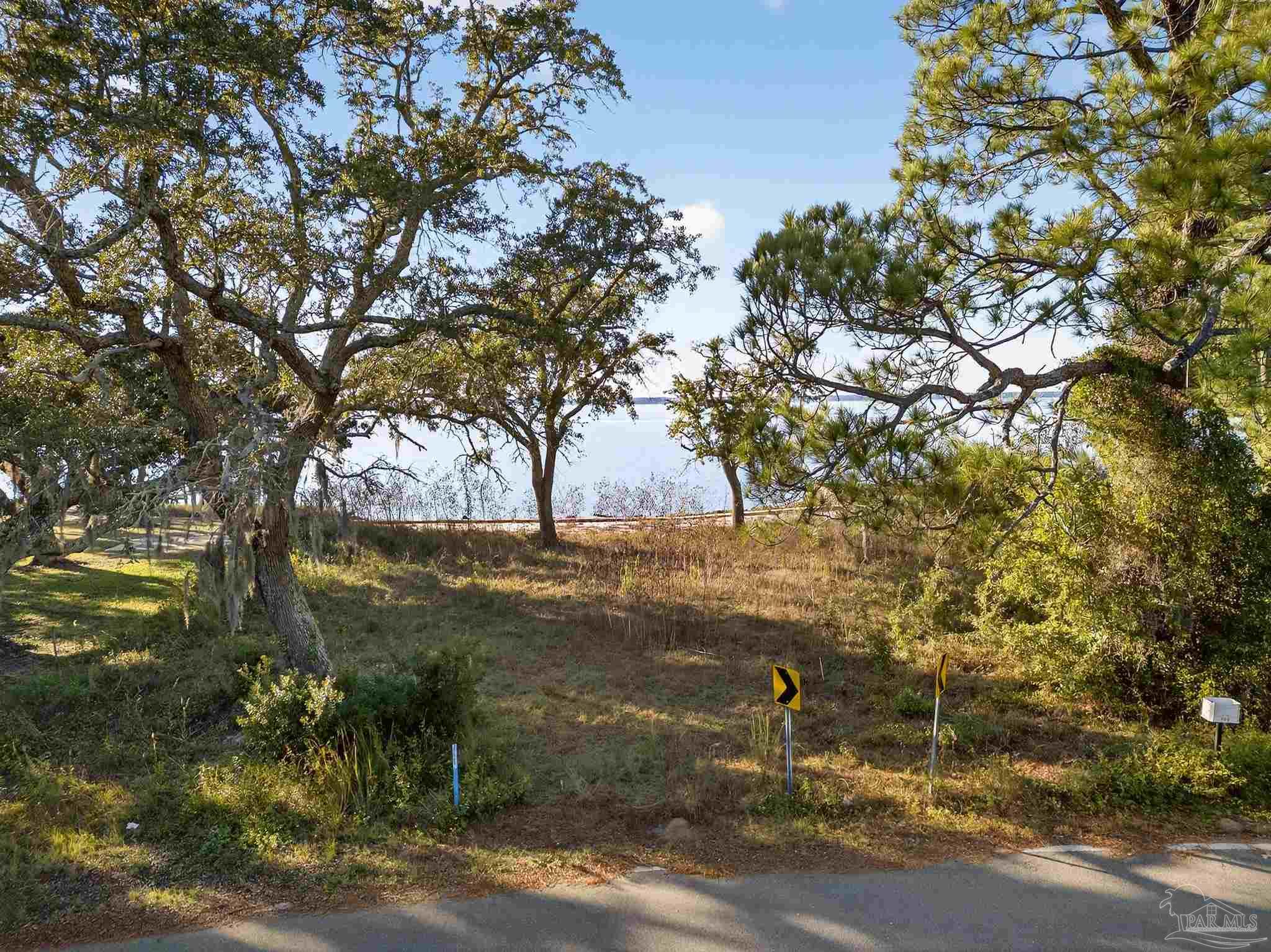 293 Garcon Point Road Milton, FL 32583 - Photo 5 of 12 a backyard of a house with lots of green space