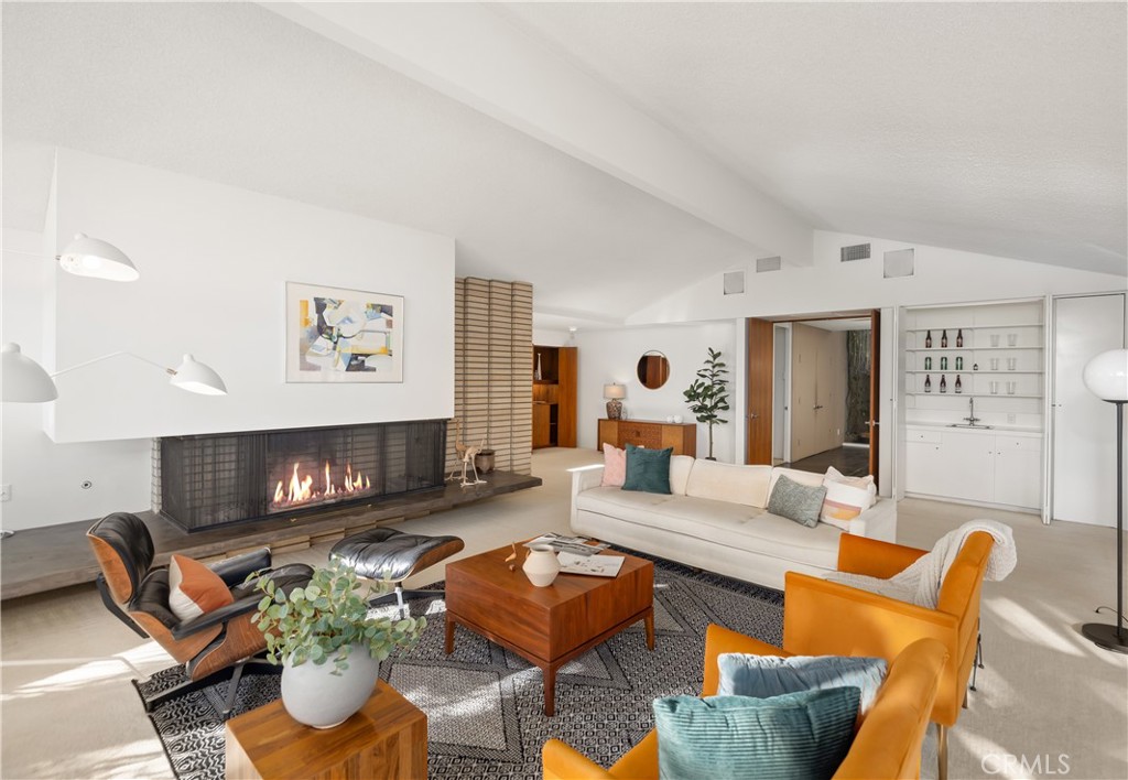 246 Angelo Place Arcadia, CA 91006 - Photo 13 of 72 a living room with furniture kitchen view and a fireplace