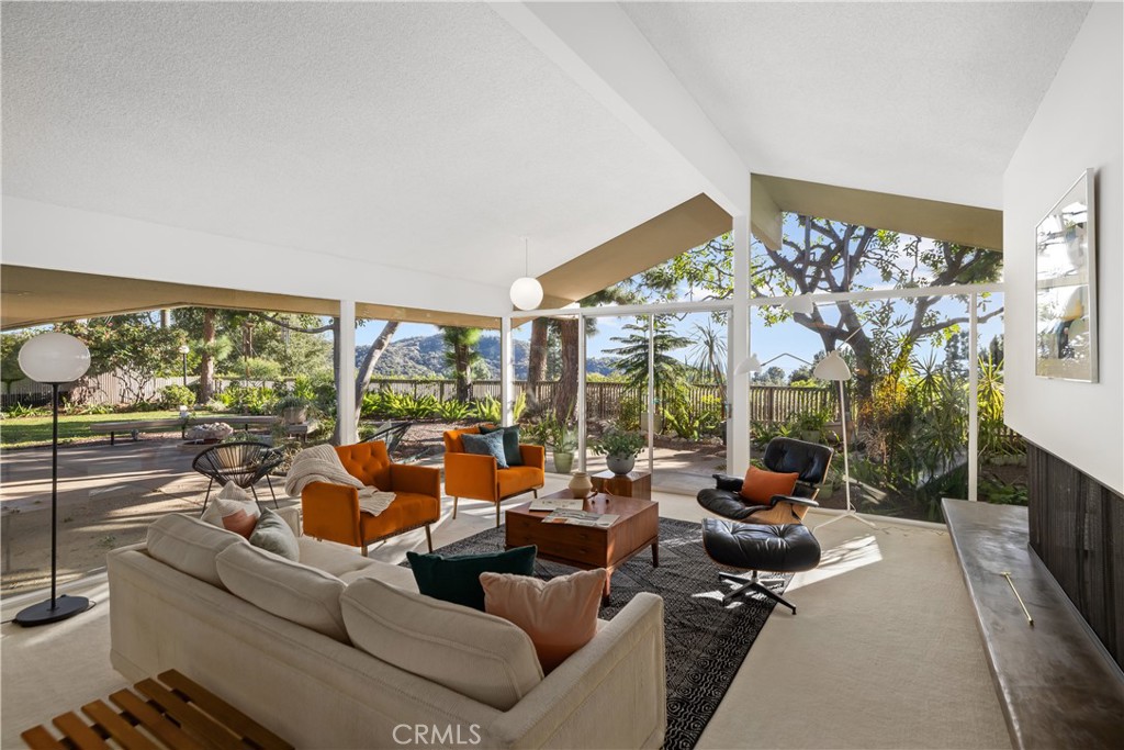 246 Angelo Place Arcadia, CA 91006 - Photo 18 of 72 a living room with furniture a floor to ceiling window and a flat screen tv