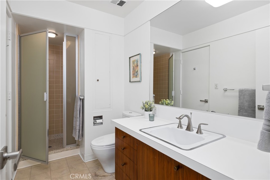 246 Angelo Place Arcadia, CA 91006 - Photo 47 of 72 a bathroom with a toilet a sink a mirror and a shower