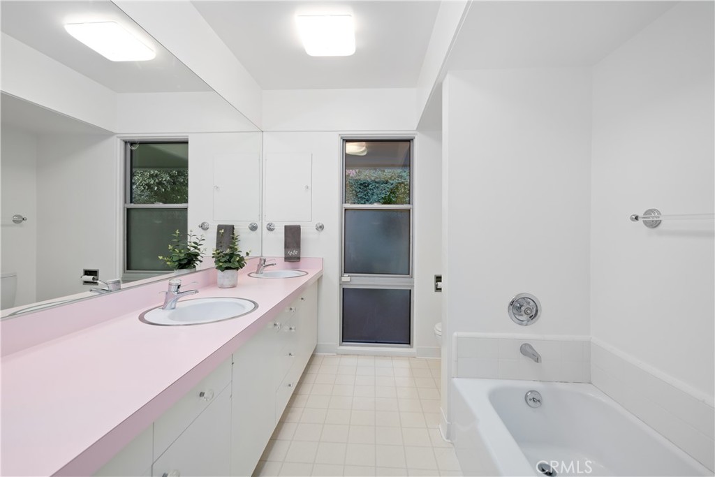 246 Angelo Place Arcadia, CA 91006 - Photo 50 of 72 a bathroom with a granite countertop tub sink and mirror