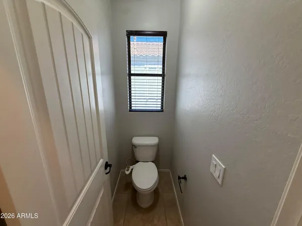 a bathroom with a toilet and a shower curtain