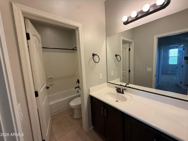 a bathroom with a double vanity sink toilet mirror and shower