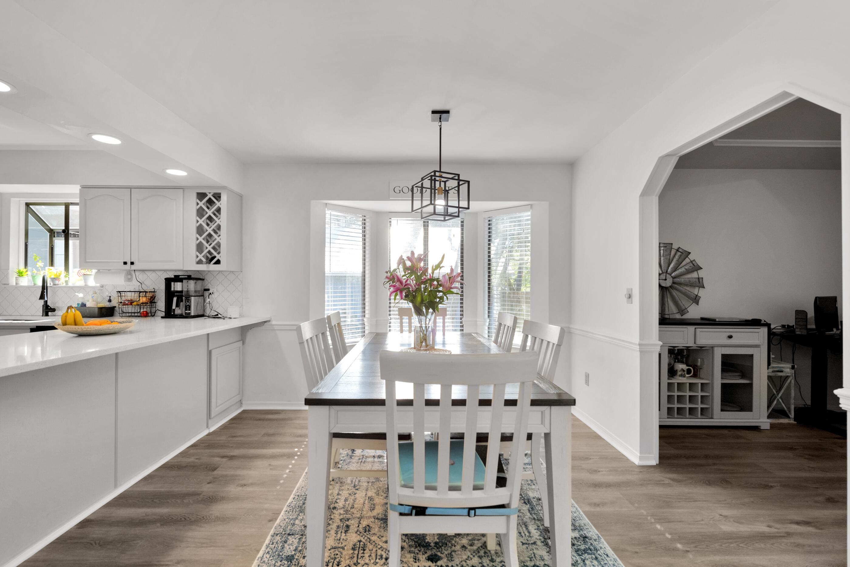 708 Caribbean Way Niceville, FL 32578 - Photo 11 of 42 a dining room with furniture a chandelier and wooden floor
