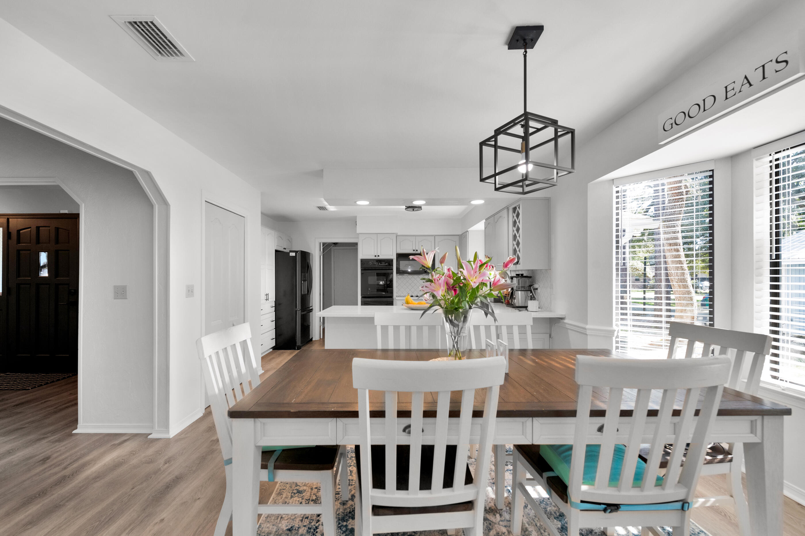 708 Caribbean Way Niceville, FL 32578 - Photo 12 of 42 a view of a dining room with furniture window and wooden floor