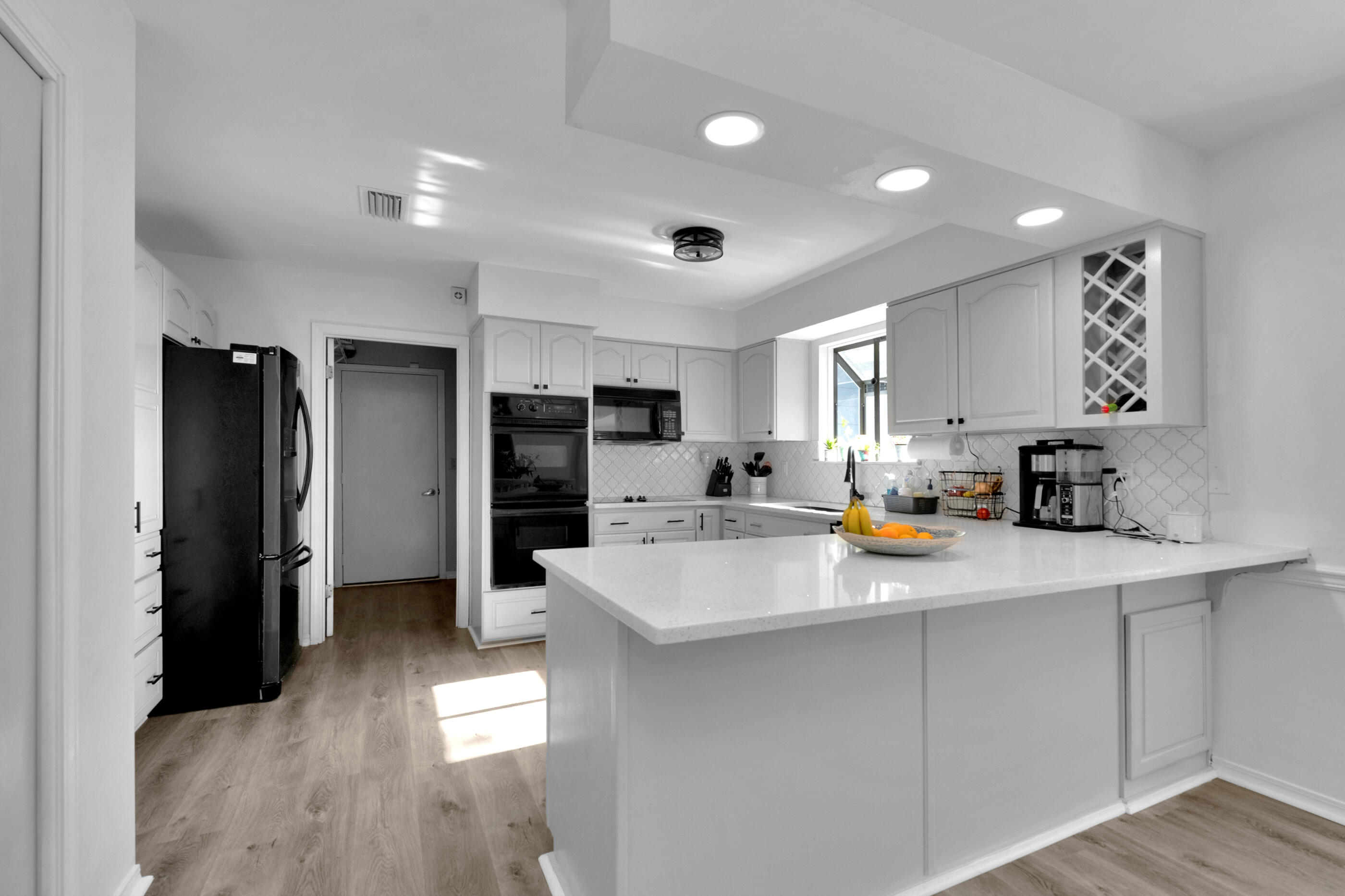 708 Caribbean Way Niceville, FL 32578 - Photo 13 of 42 a kitchen with stainless steel appliances a refrigerator sink and cabinets