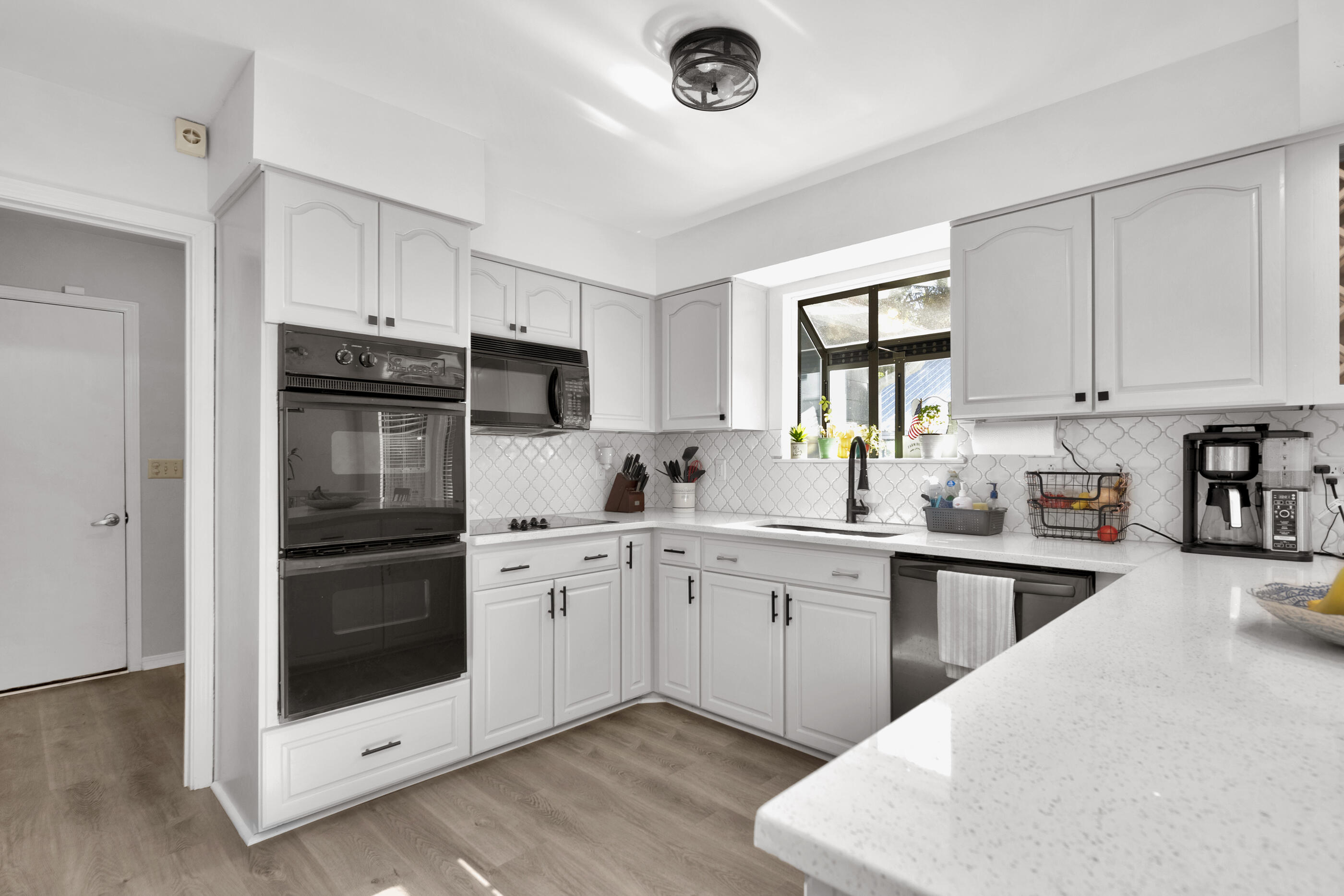 708 Caribbean Way Niceville, FL 32578 - Photo 15 of 42 a kitchen with a sink stove and cabinets