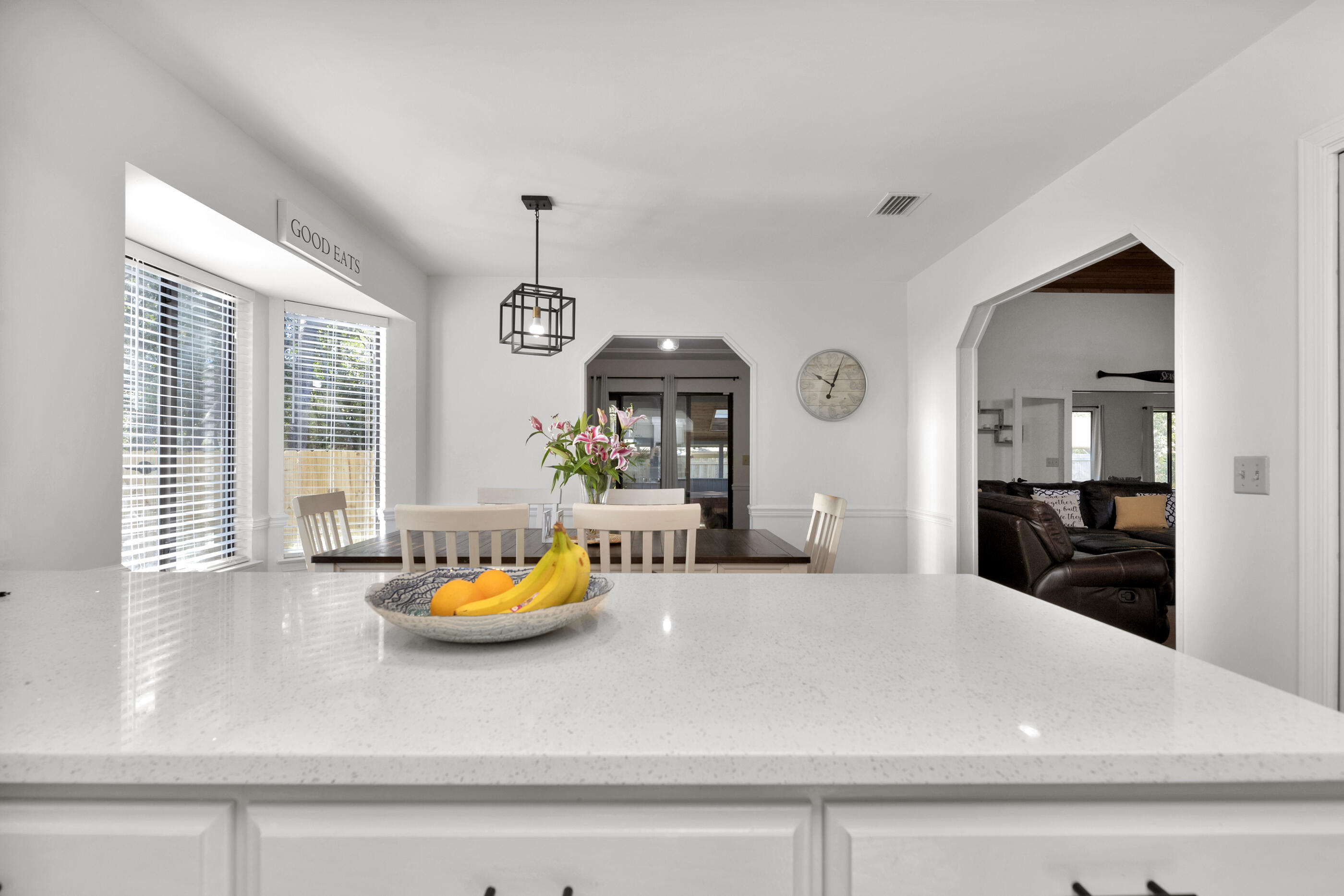 708 Caribbean Way Niceville, FL 32578 - Photo 18 of 42 a kitchen with a refrigerator a stove and white cabinets