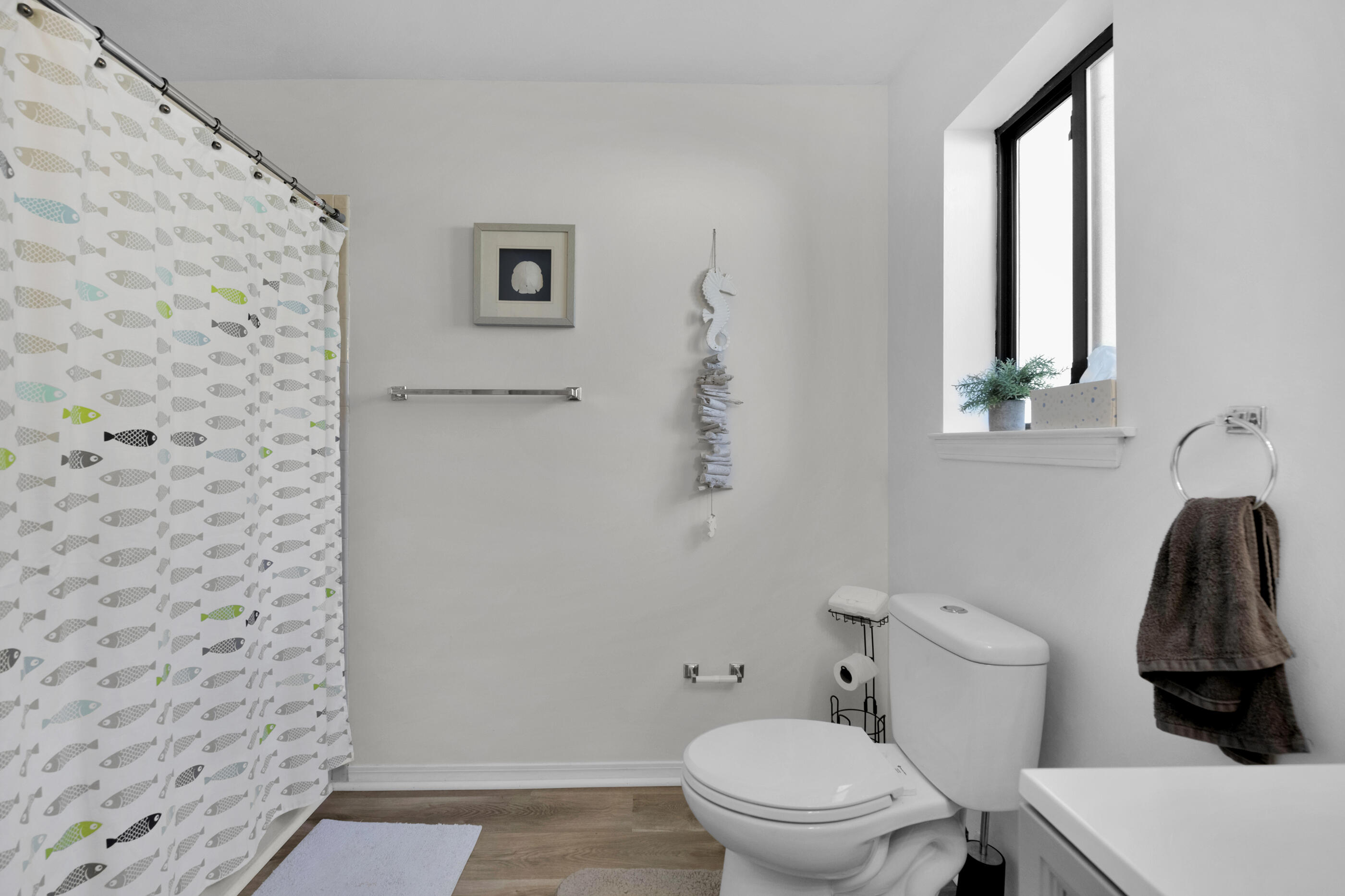 708 Caribbean Way Niceville, FL 32578 - Photo 24 of 42 a white toilet sitting next to a shower curtain