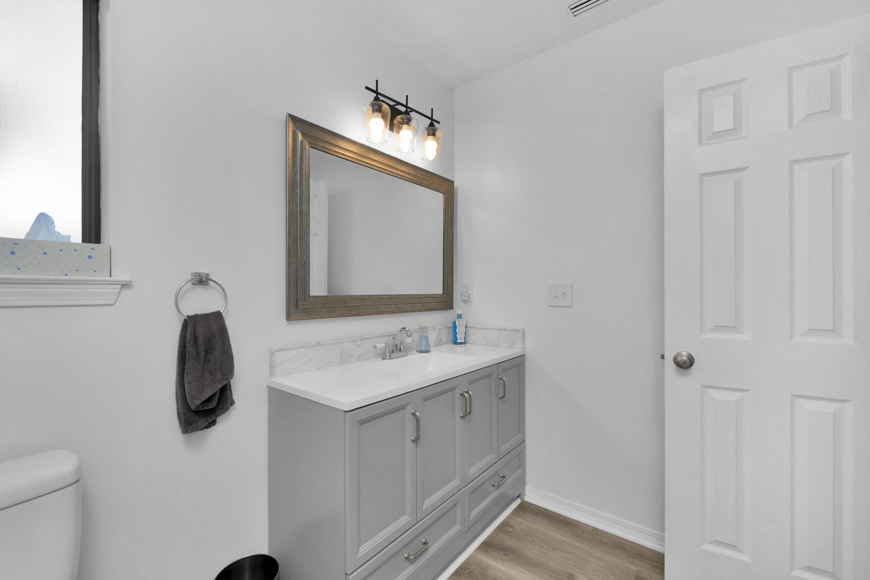 708 Caribbean Way Niceville, FL 32578 - Photo 25 of 42 a bathroom with a toilet sink and mirror