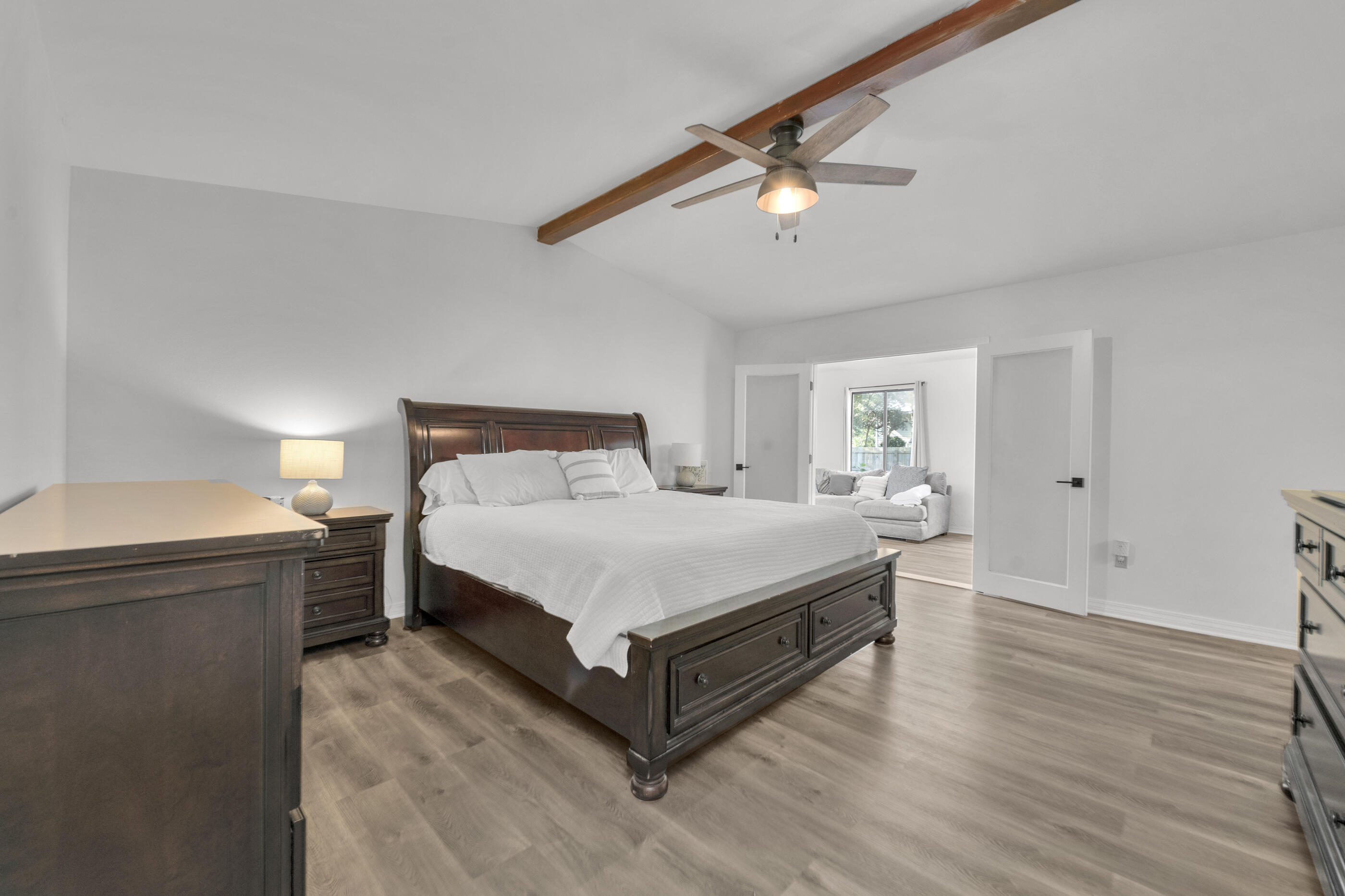 708 Caribbean Way Niceville, FL 32578 - Photo 26 of 42 a bedroom with a bed and wooden floor