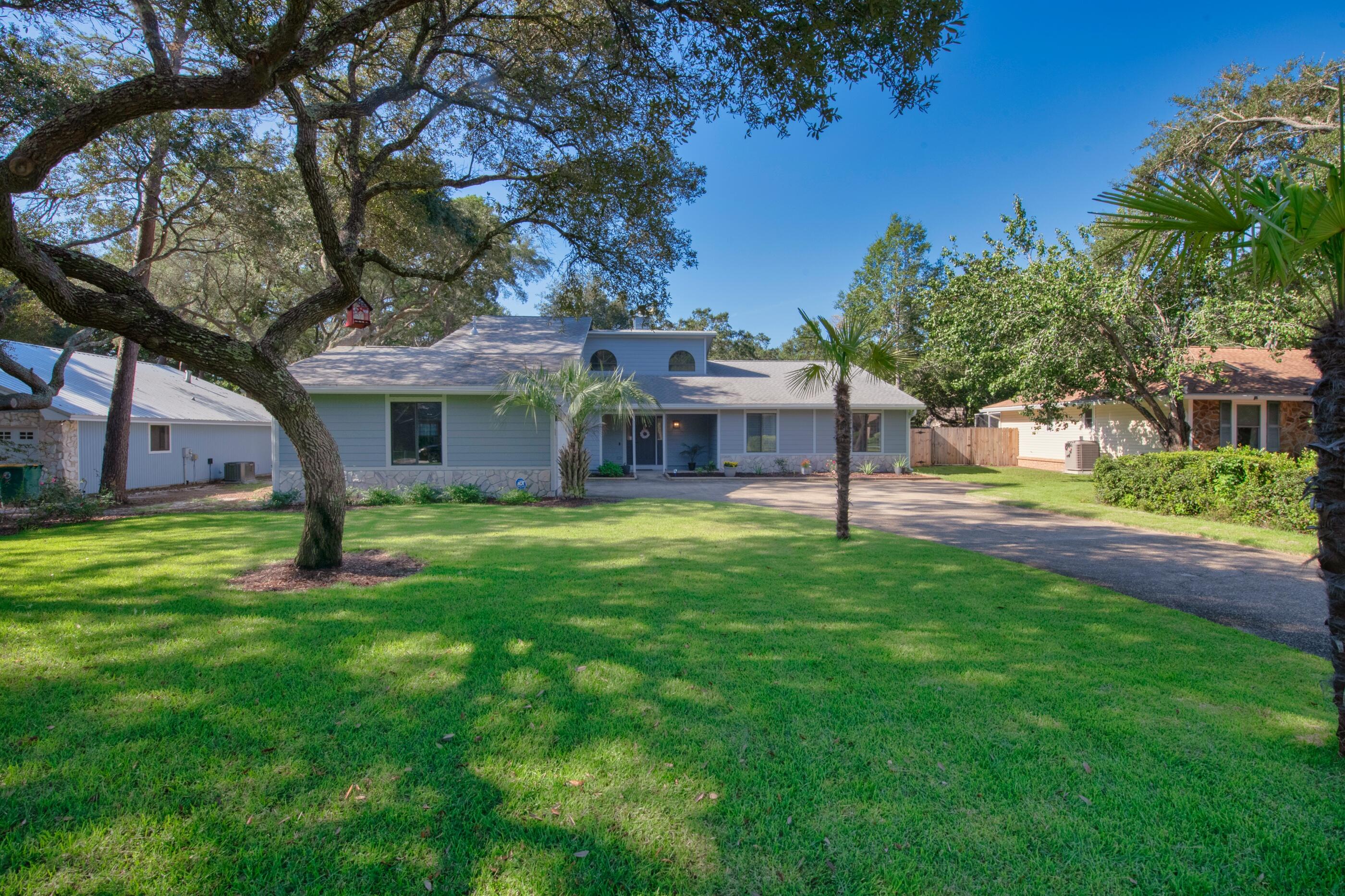 708 Caribbean Way Niceville, FL 32578 - Photo 3 of 42 a front view of a house with a yard