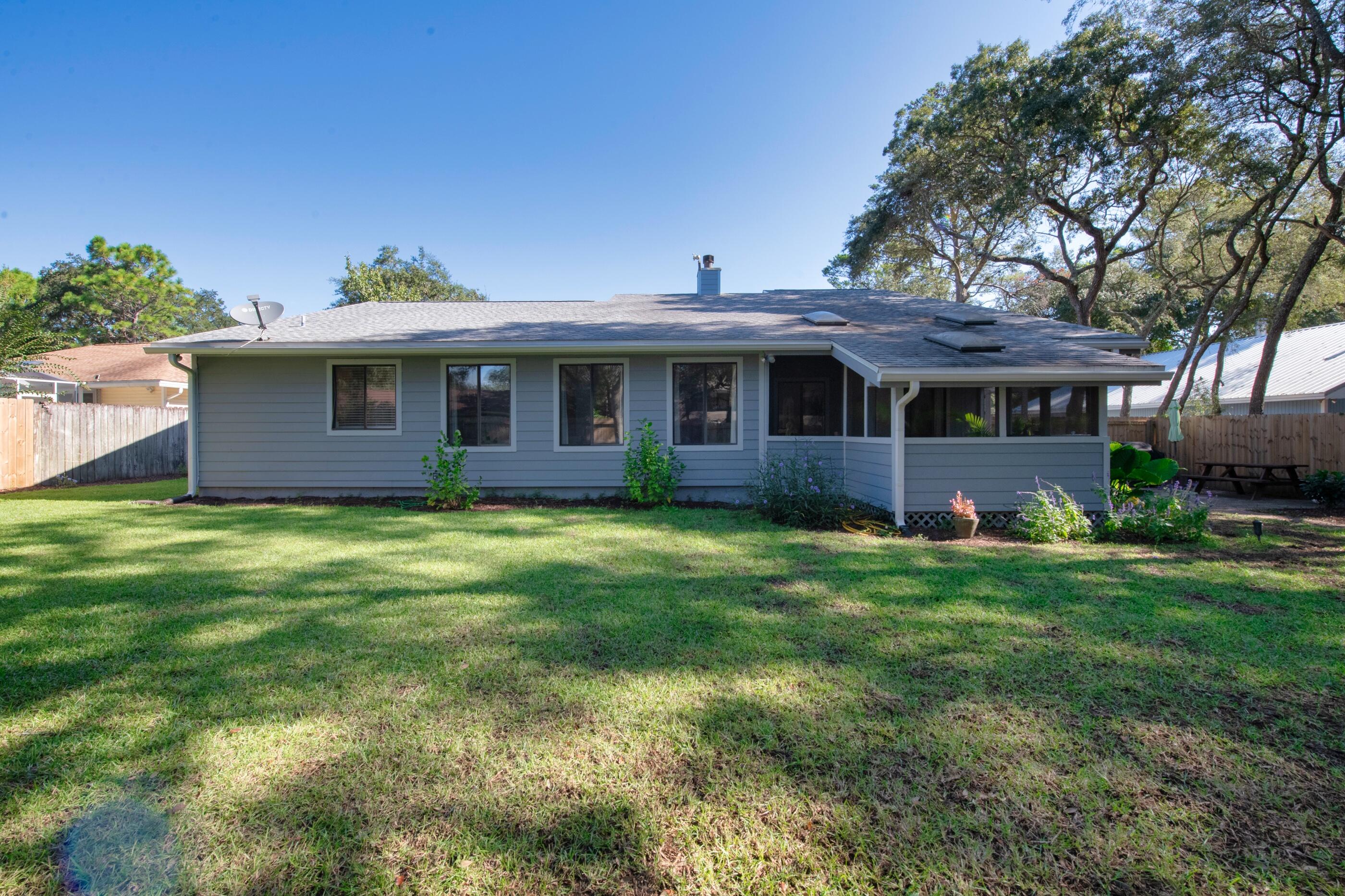 708 Caribbean Way Niceville, FL 32578 - Photo 42 of 42 a front view of a house with a garden