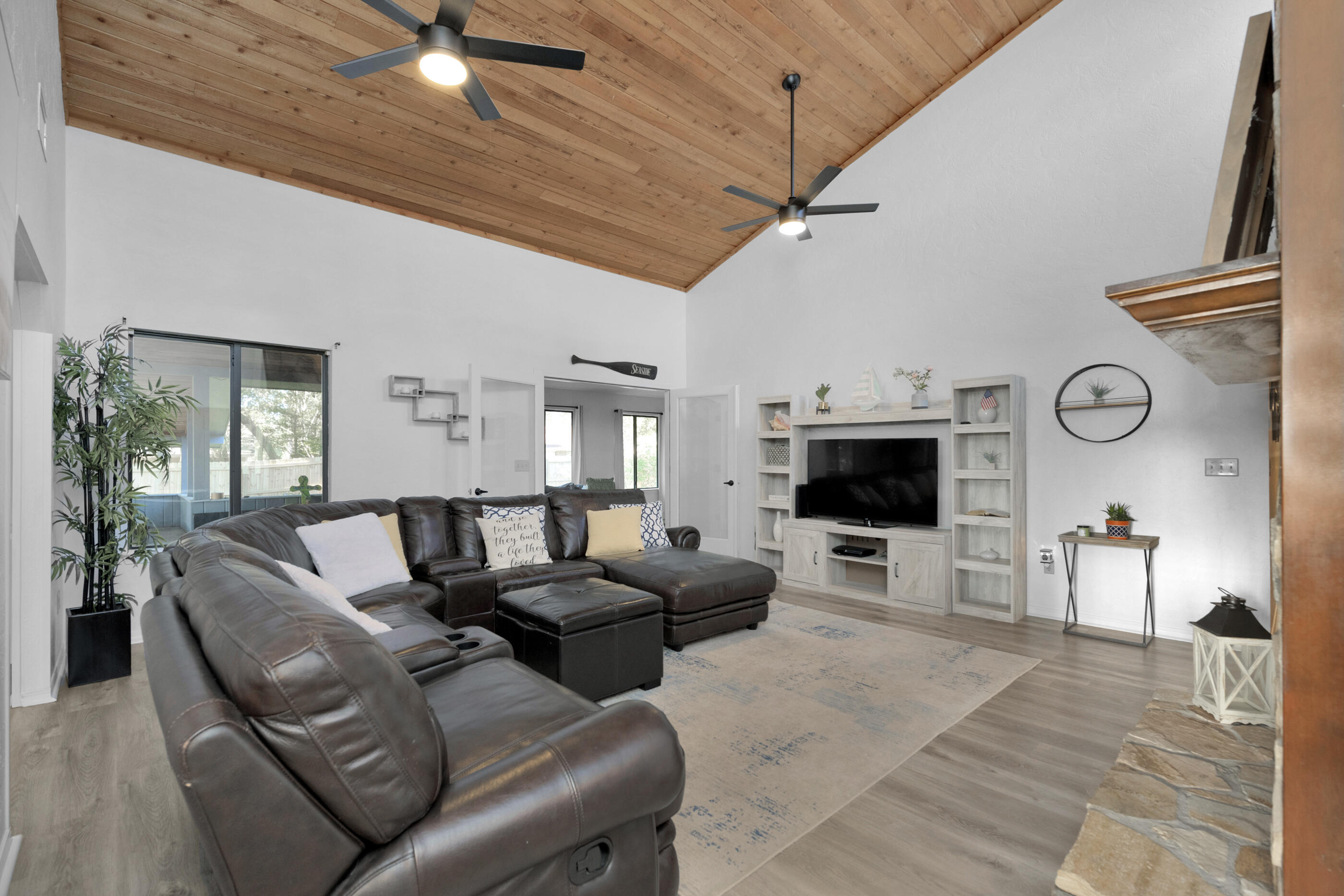 708 Caribbean Way Niceville, FL 32578 - Photo 7 of 42 a living room with furniture a flat screen tv and a fireplace