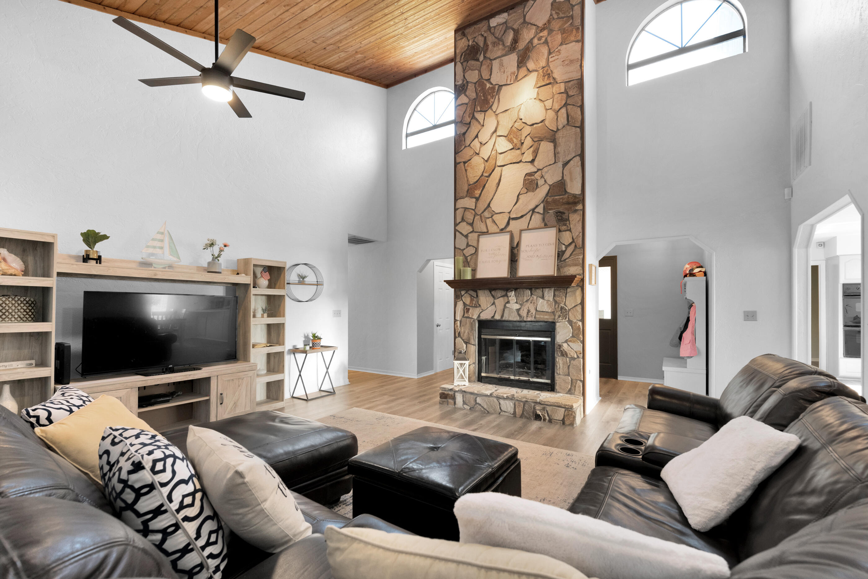 708 Caribbean Way Niceville, FL 32578 - Photo 9 of 42 a living room with furniture a flat screen tv and a fireplace