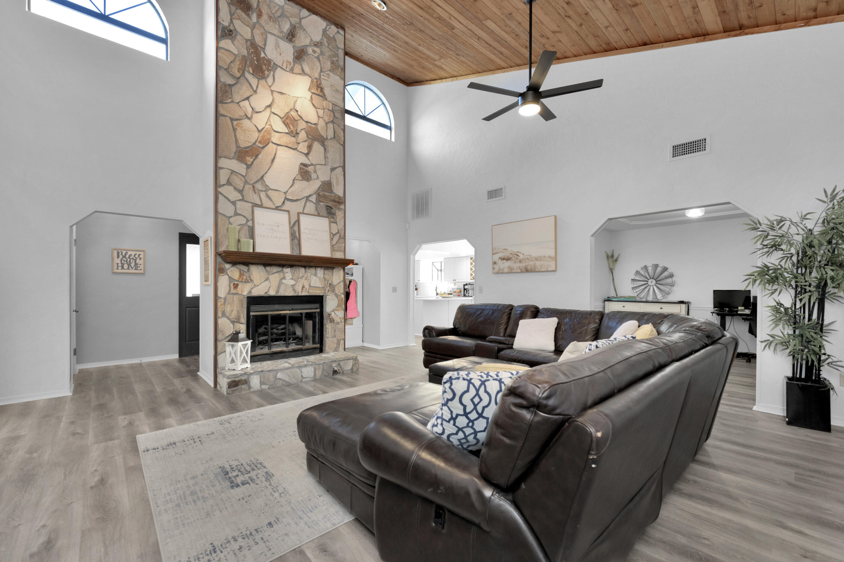 708 Caribbean Way Niceville, FL 32578 - Photo 10 of 42 a living room with furniture a fireplace and a dining table with wooden floor