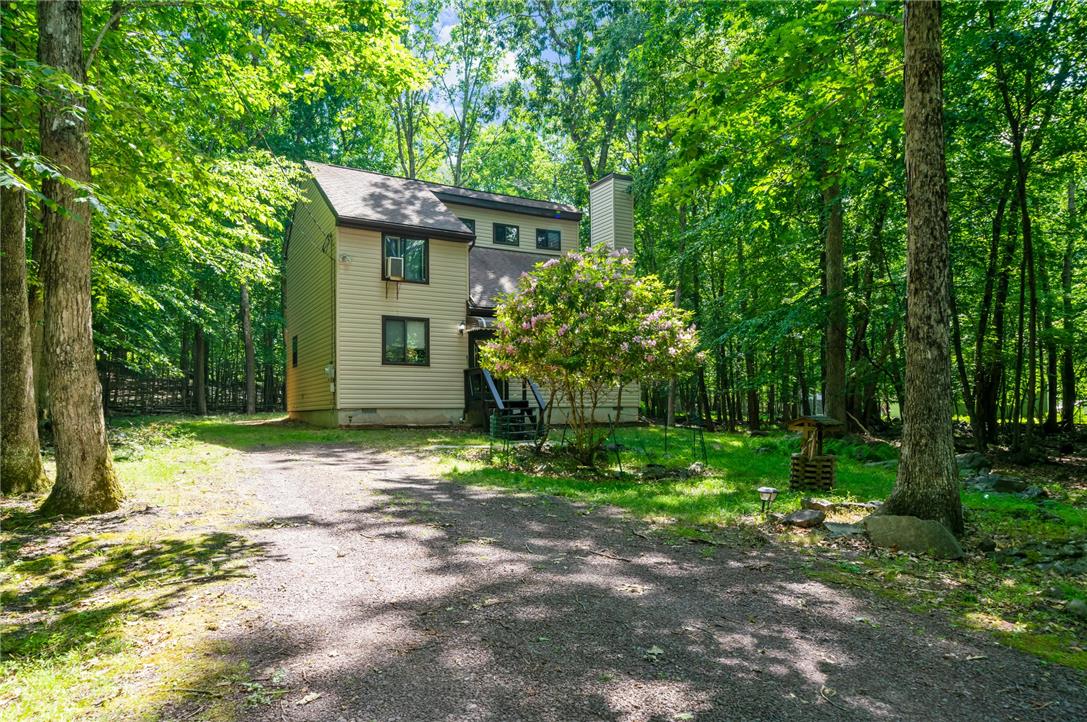 222 Powder Horn Road Henryville, PA 18332 - Photo 3 of 25 A private driveway leads to a secluded residence nestled amongst a verdant, mature treed lot.