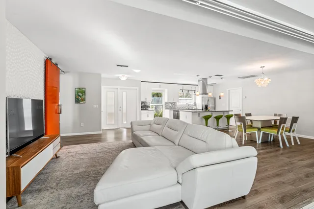a bathroom with a granite countertop sink vanity mirror and toilet