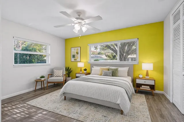 a view of a house with a yard and potted plants
