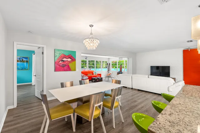 a kitchen with stainless steel appliances granite countertop a sink a stove and a refrigerator