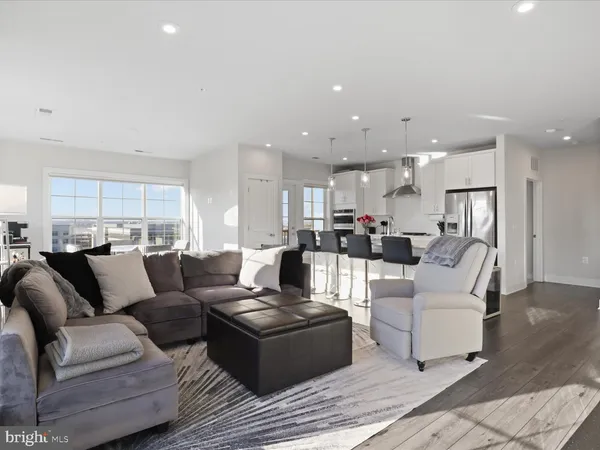 a living room with furniture and kitchen view