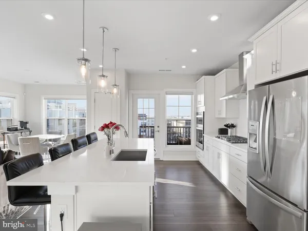 a large kitchen with a large counter top appliances and cabinets