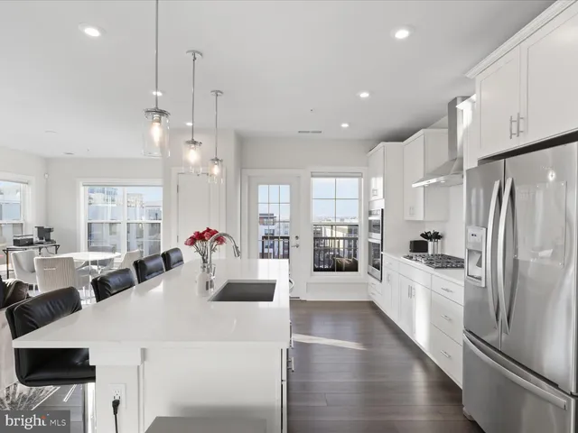 a large kitchen with a large counter top appliances and cabinets