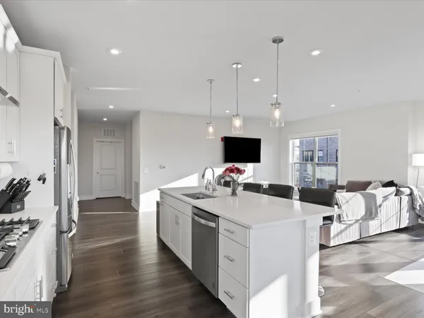 a view of living room kitchen and windows