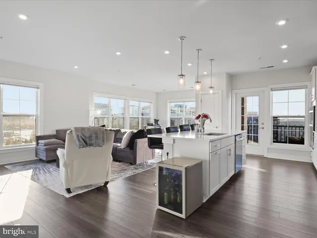 a large white kitchen with a large window and white cabinets