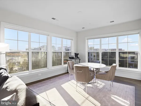a living room with furniture and large windows