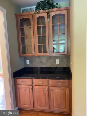 a view of kitchen with granite countertop cabinets and wooden floor