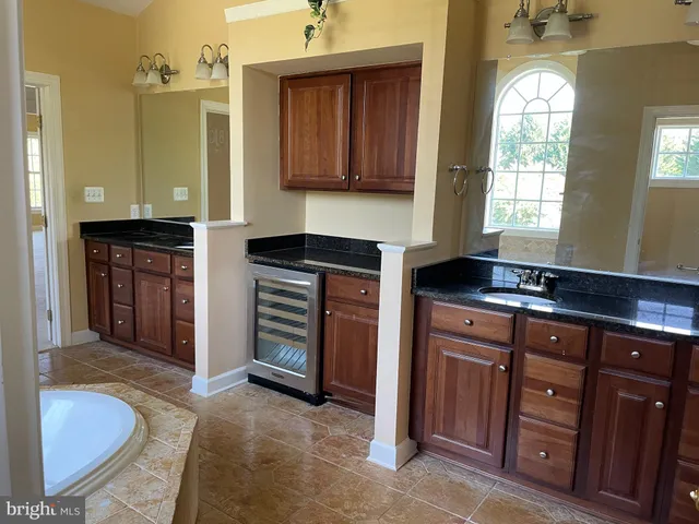 a kitchen with stainless steel appliances granite countertop a sink and a stove