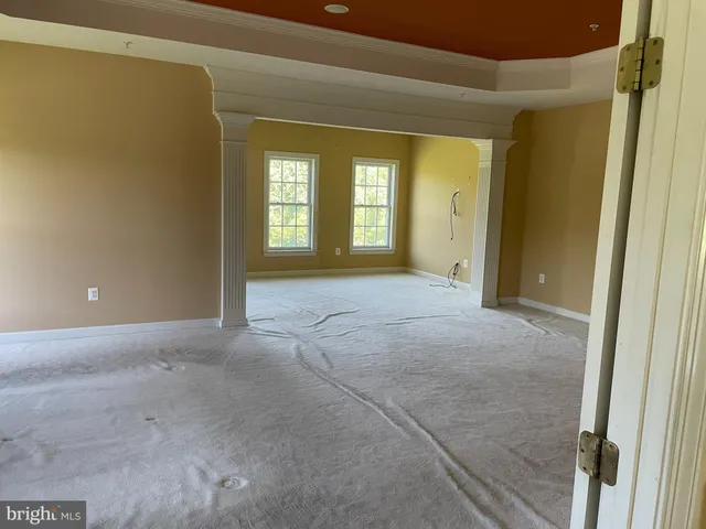 a living room with furniture a lamp wooden floor and a window