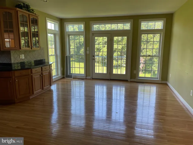 a view of an entryway with wooden floor and windows