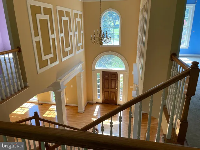 a view of staircase with two frames on the wall