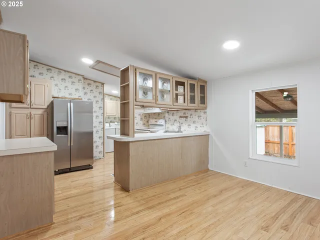a kitchen with stainless steel appliances a refrigerator and a stove top oven
