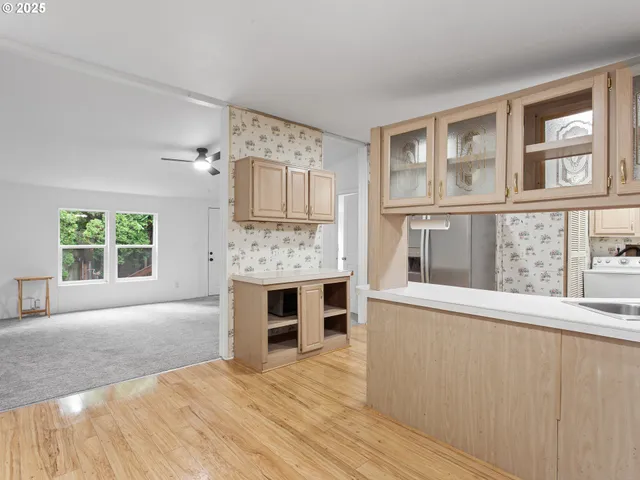 a view of empty room with a fireplace and windows
