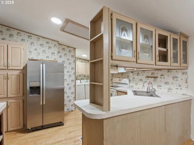 a kitchen with stainless steel appliances granite countertop a refrigerator and a sink