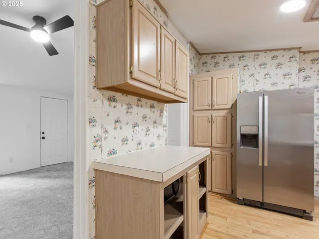 a kitchen with stainless steel appliances a refrigerator and a stove