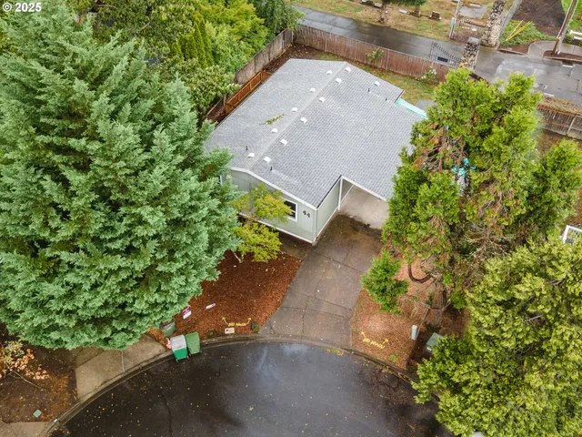 an aerial view of a house with a yard and garden