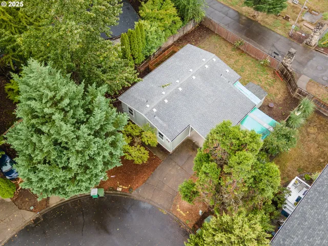 an aerial view of a house with a yard and garden