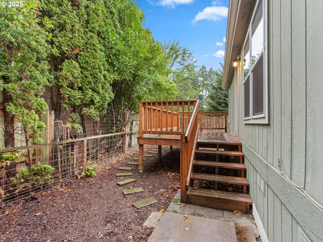 a view of a yard with stairs and wooden floor