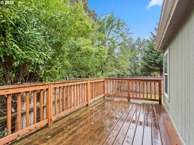 a balcony with wooden floor and fence