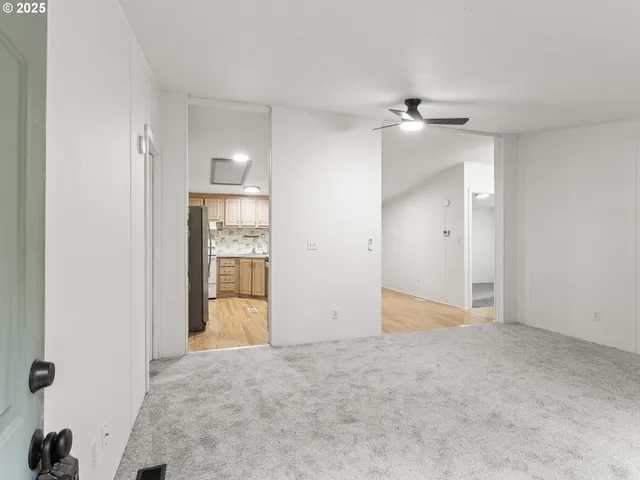 an empty room with closet and windows
