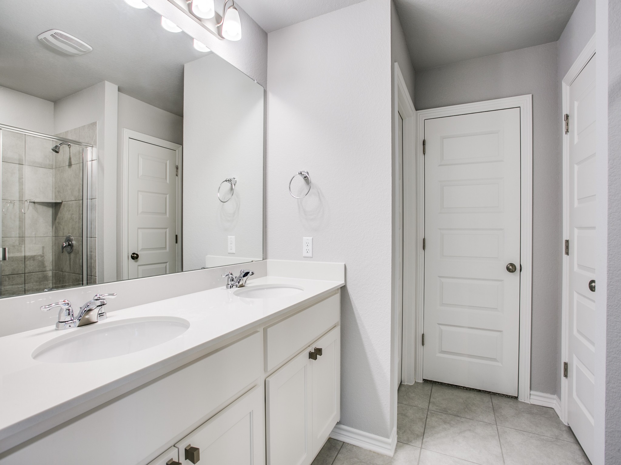 508 Rearing Mare Pass Georgetown, TX 78626 - Photo 15 of 26 Bathroom with double vanity, a stall shower, baseboards, and tile patterned floors