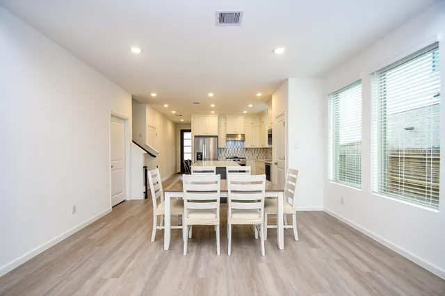a dining room with furniture and wooden floor