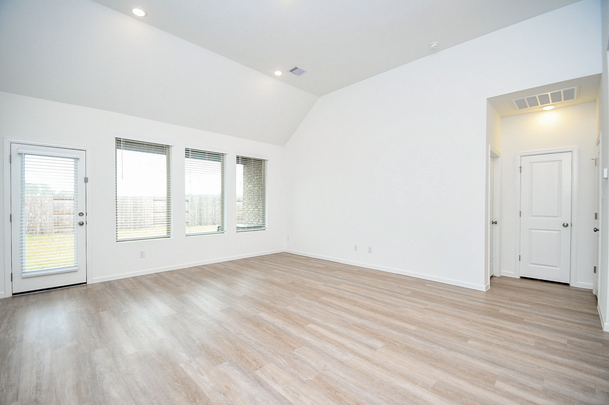 28722 Mount Bonnell Drive New Caney, TX 77357 - Photo 13 of 32 an empty room with wooden floor and windows