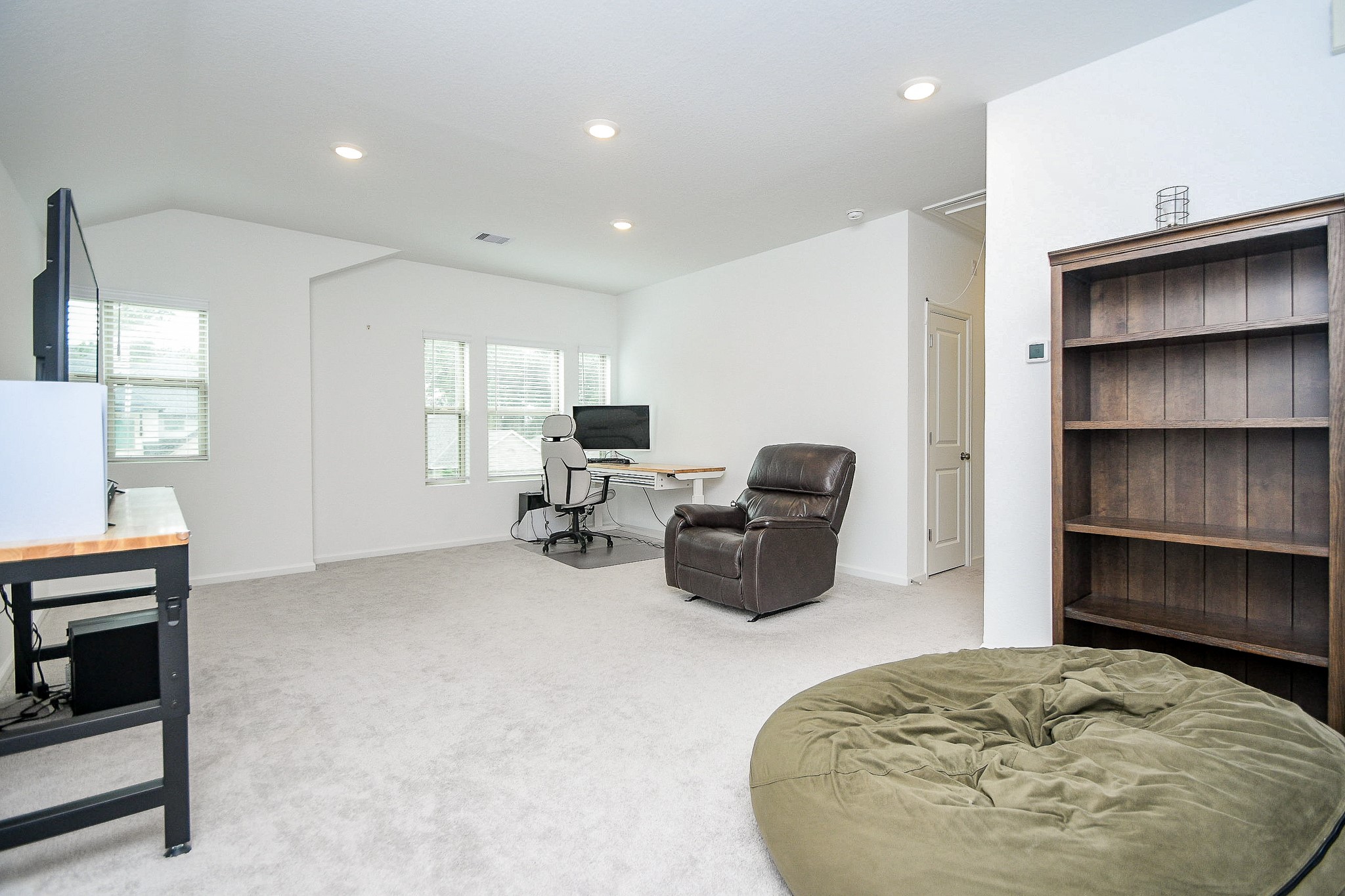 28722 Mount Bonnell Drive New Caney, TX 77357 - Photo 14 of 32 a living room with furniture and a flat screen tv