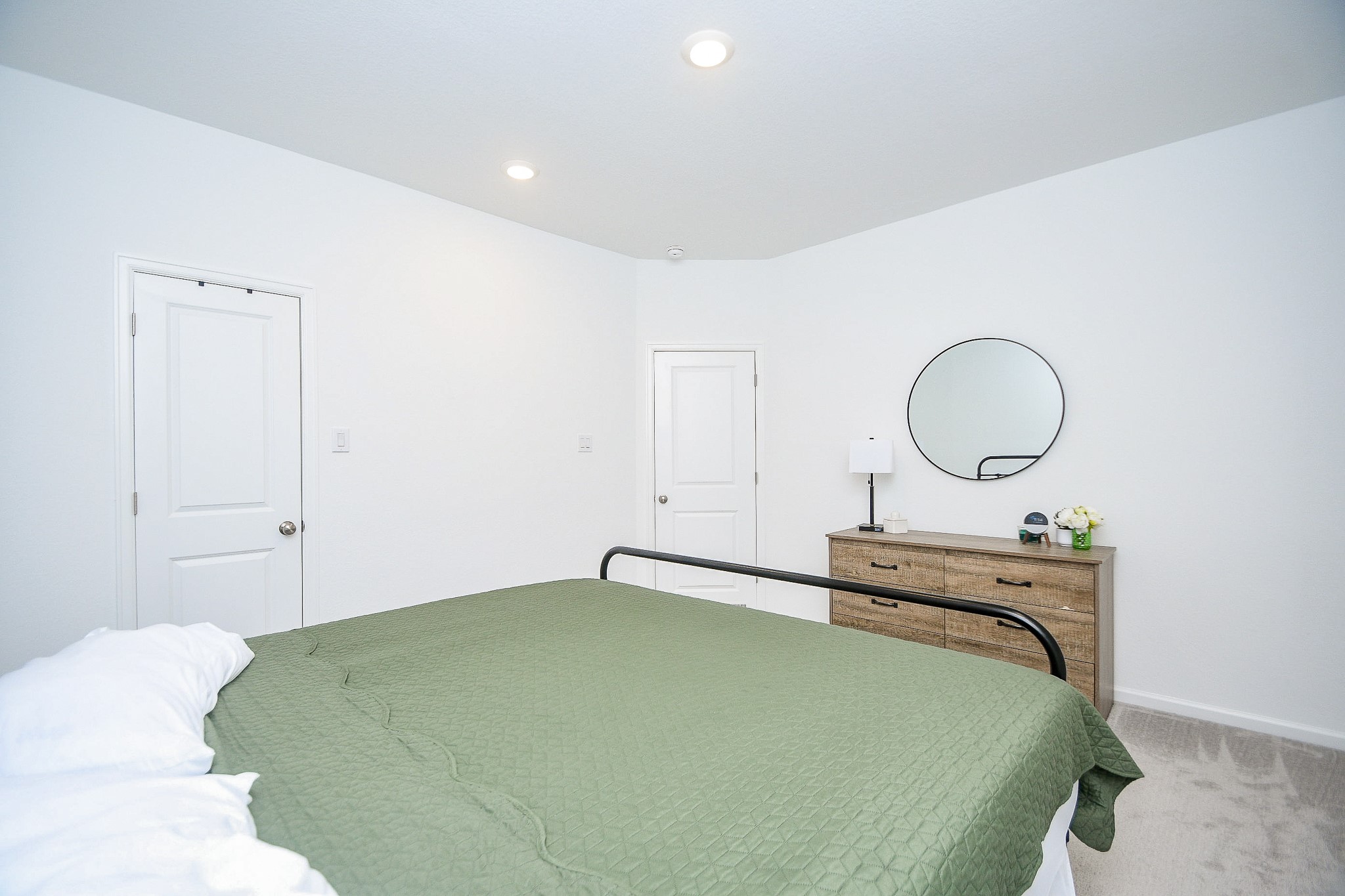 28722 Mount Bonnell Drive New Caney, TX 77357 - Photo 20 of 32 a bedroom with a bed and a chandelier
