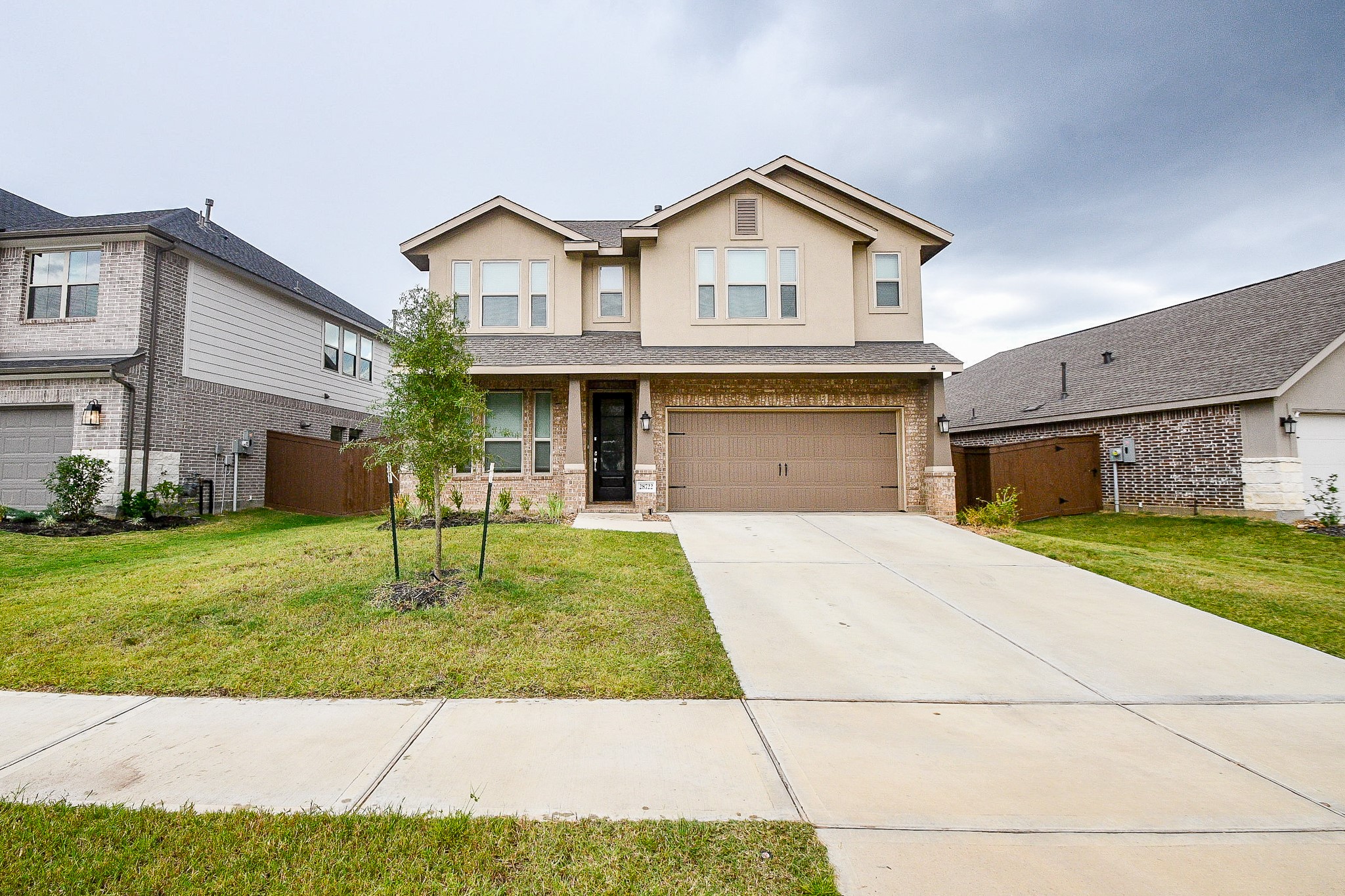 28722 Mount Bonnell Drive New Caney, TX 77357 - Photo 2 of 32 a front view of a house with a yard and garage